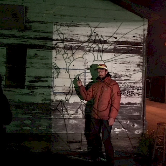 The artist started by projecting a sketch onto the side of the building at night and tracing it with charcoal. gallery image